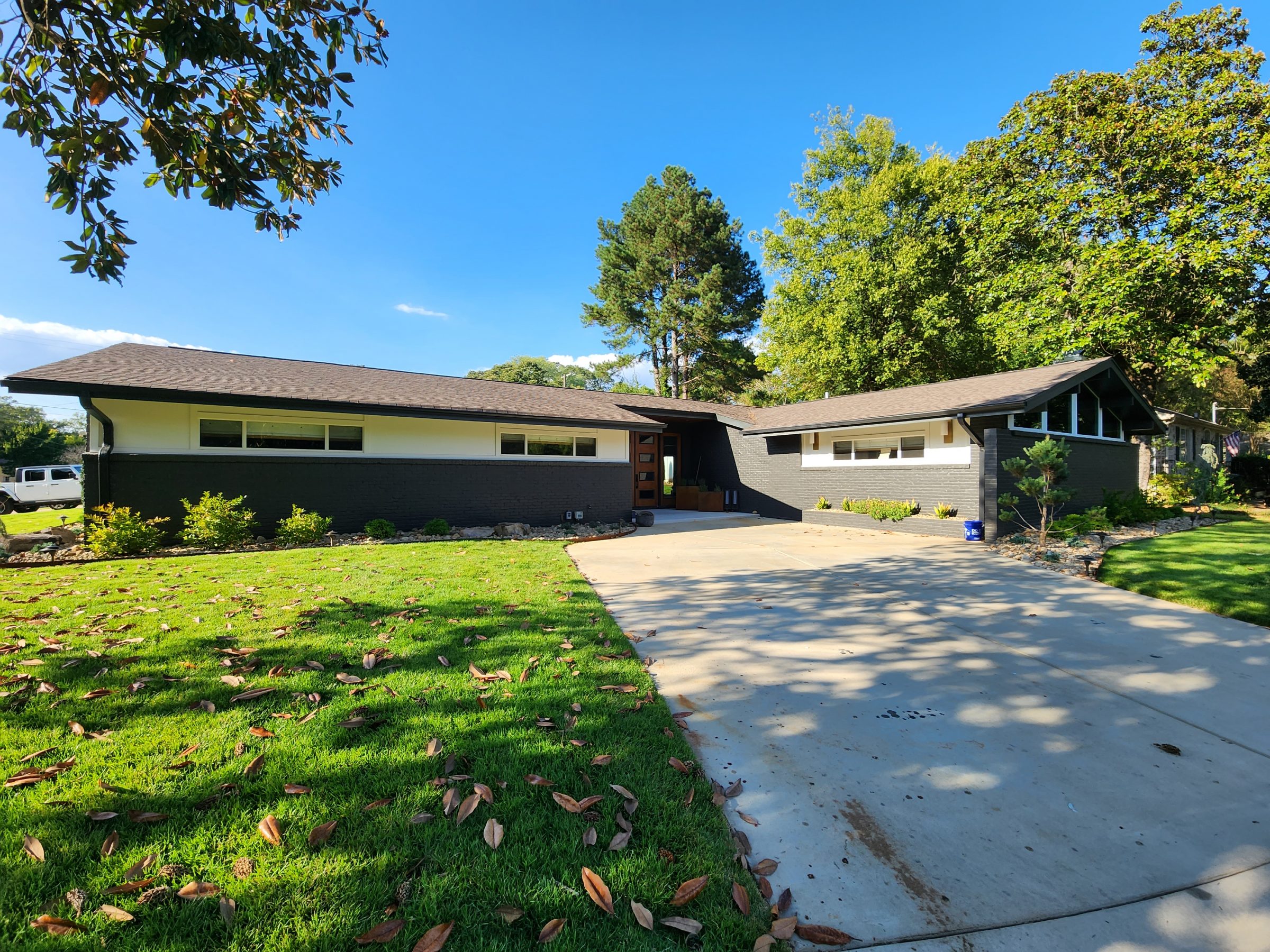 Modern single-story house with green lawn.