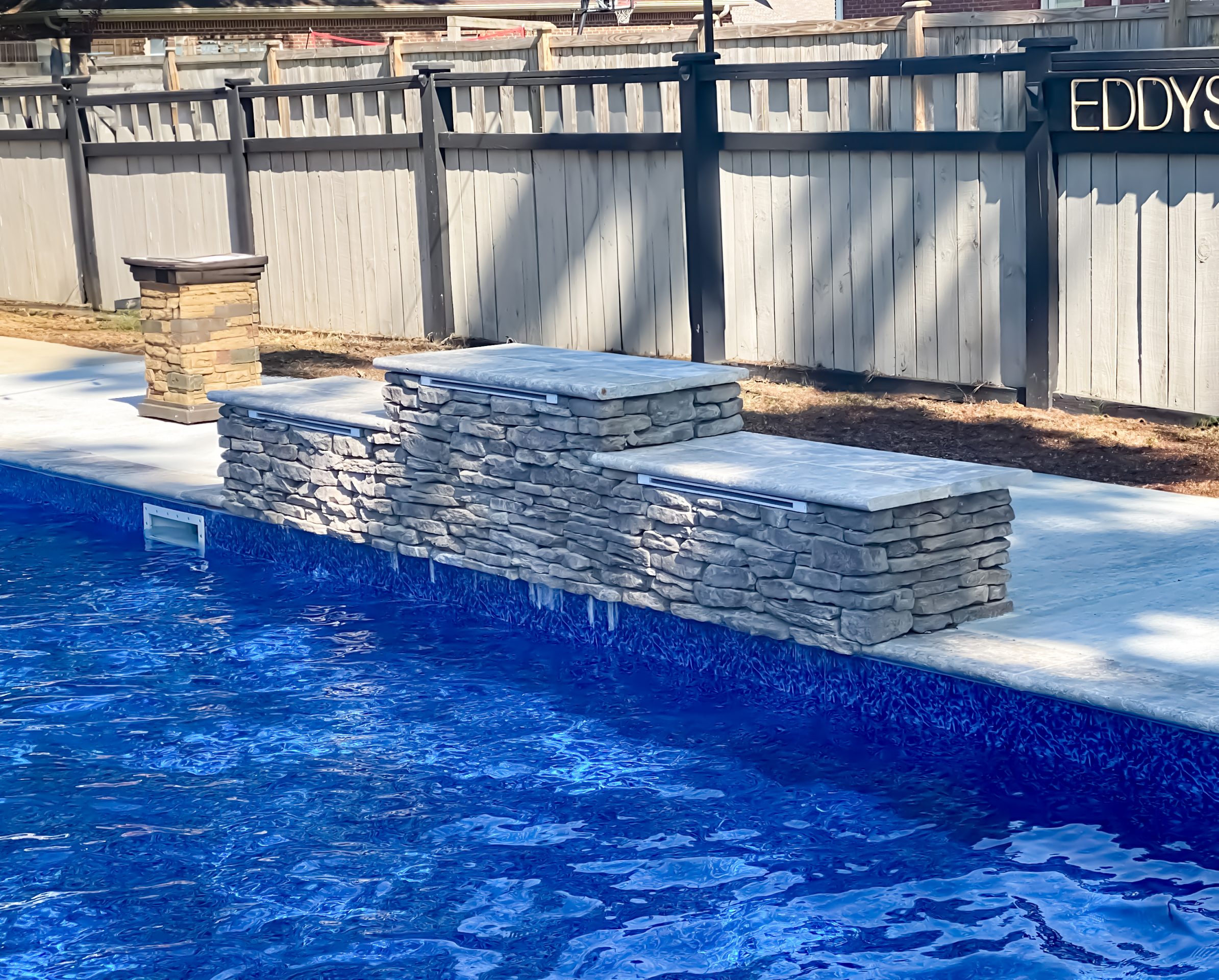 Stone waterfall feature by a pool