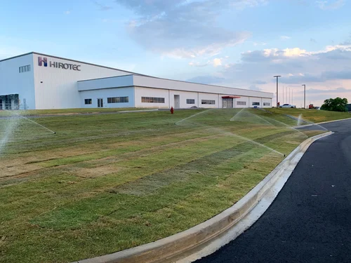 Industrial building with lawn sprinklers.