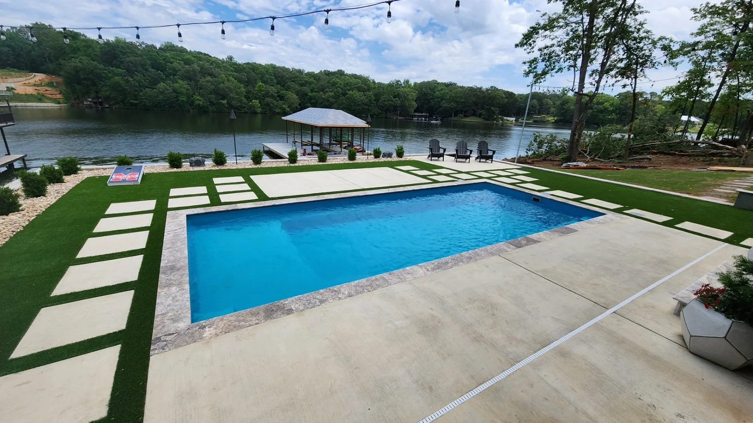 Lakeside pool with patio and lawn