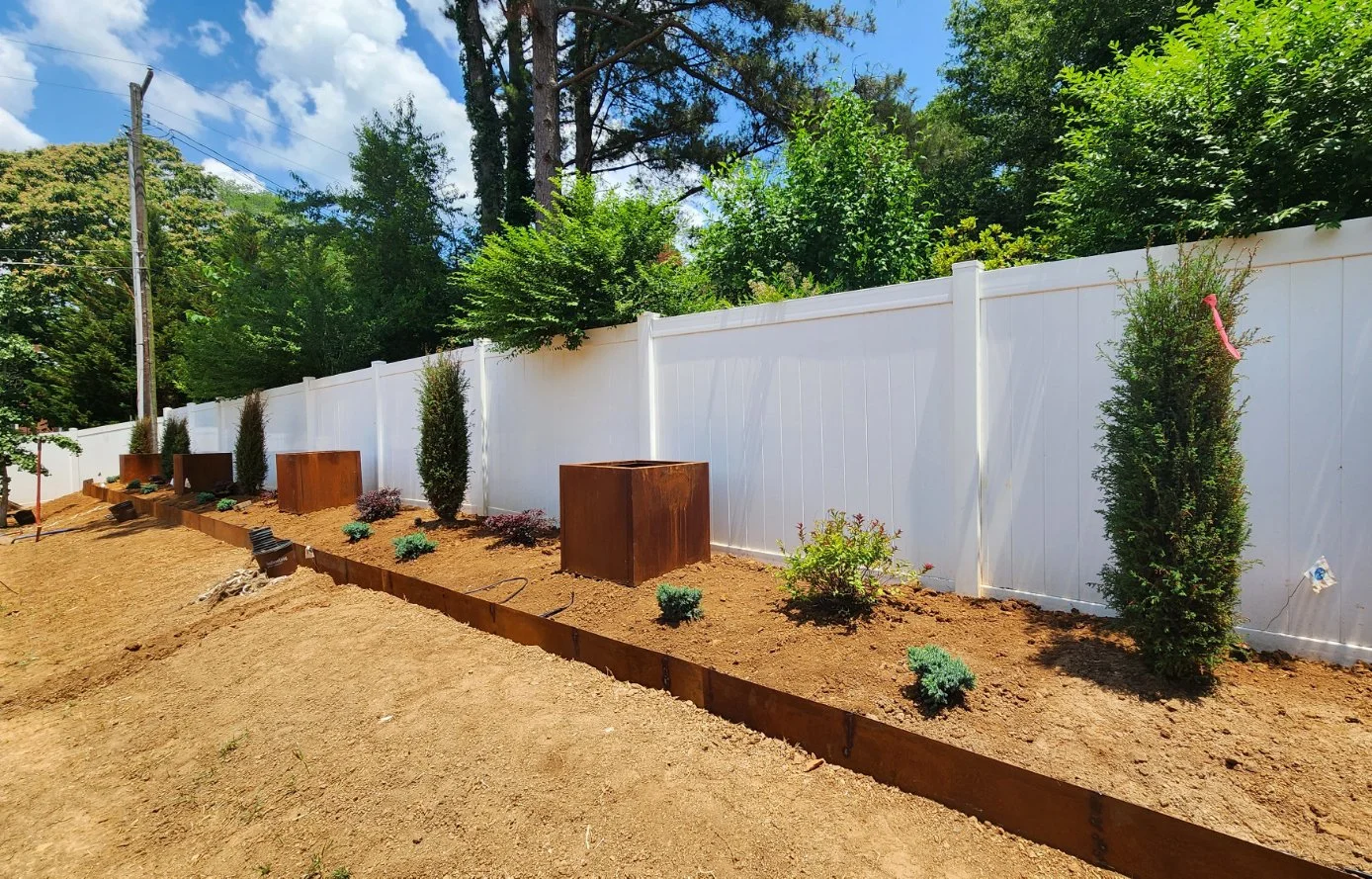 Garden with plants and white fence