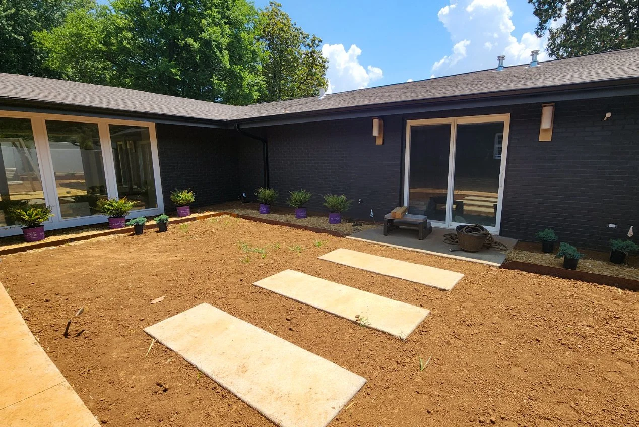 Backyard with patio and plants.
