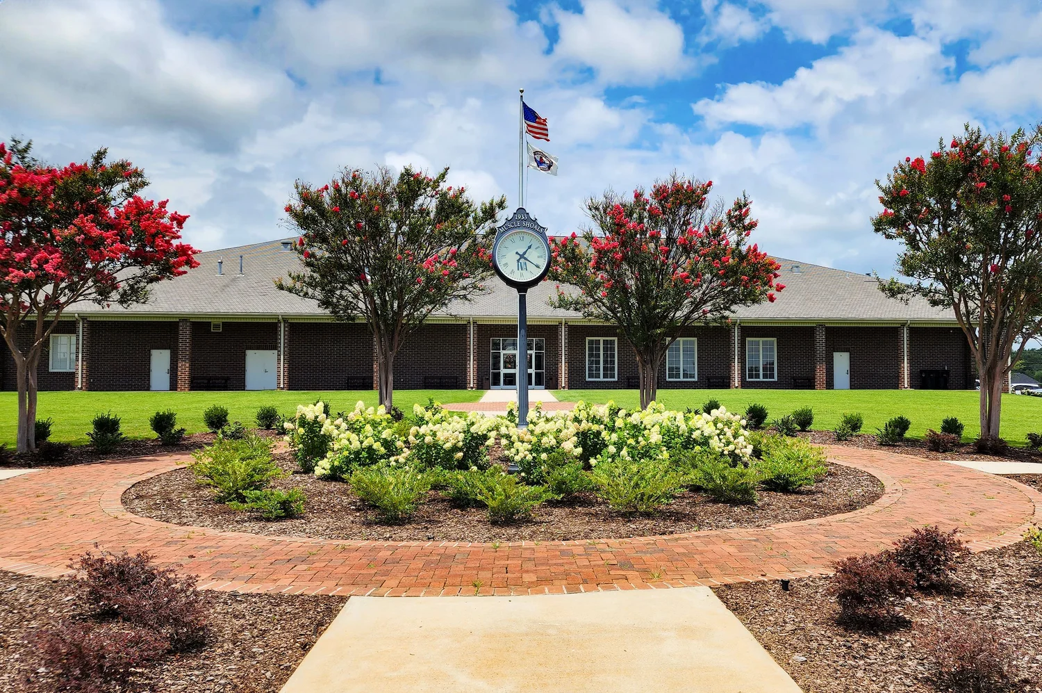 Building with flag and garden in foreground
