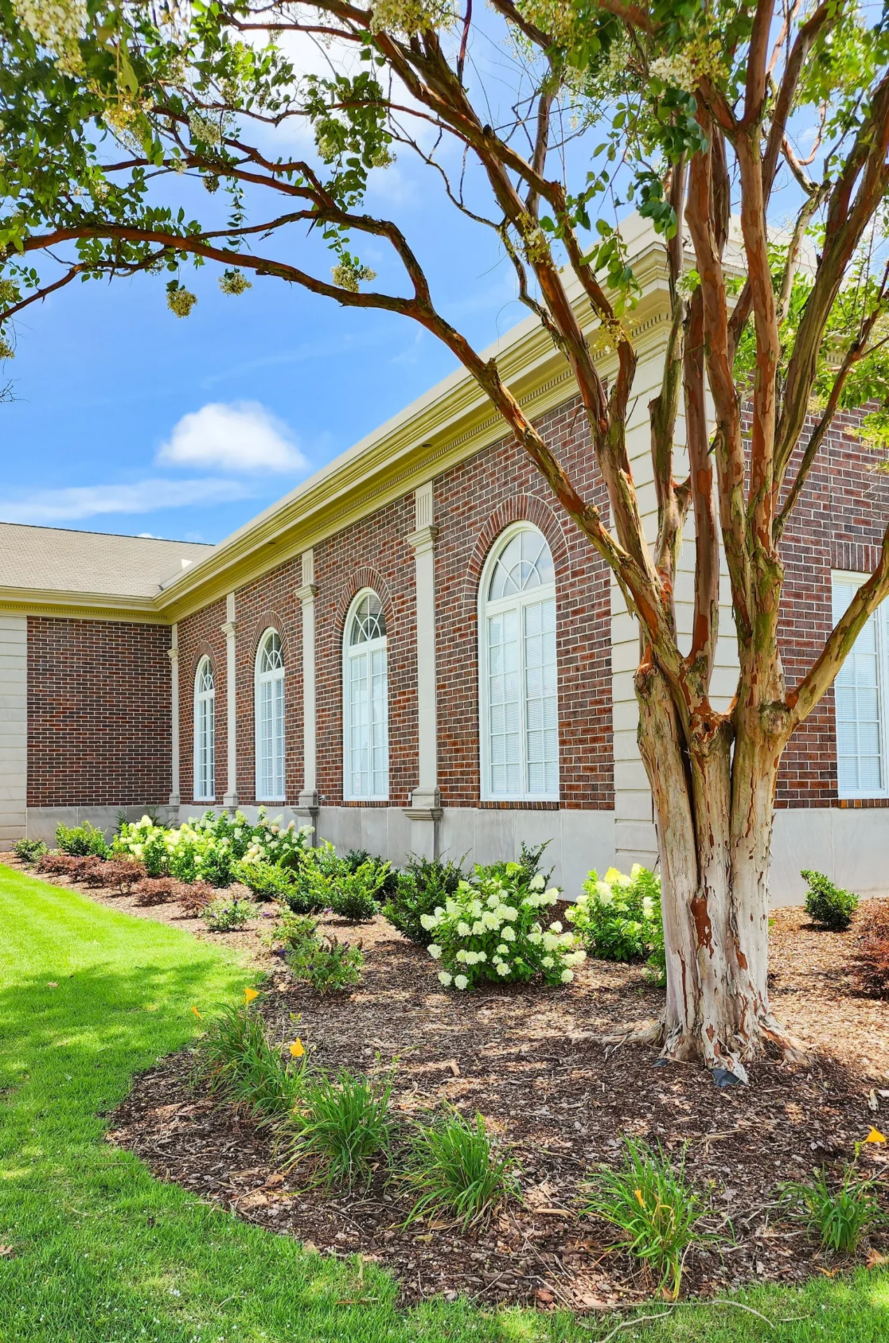 Elegant brick building with garden landscaping