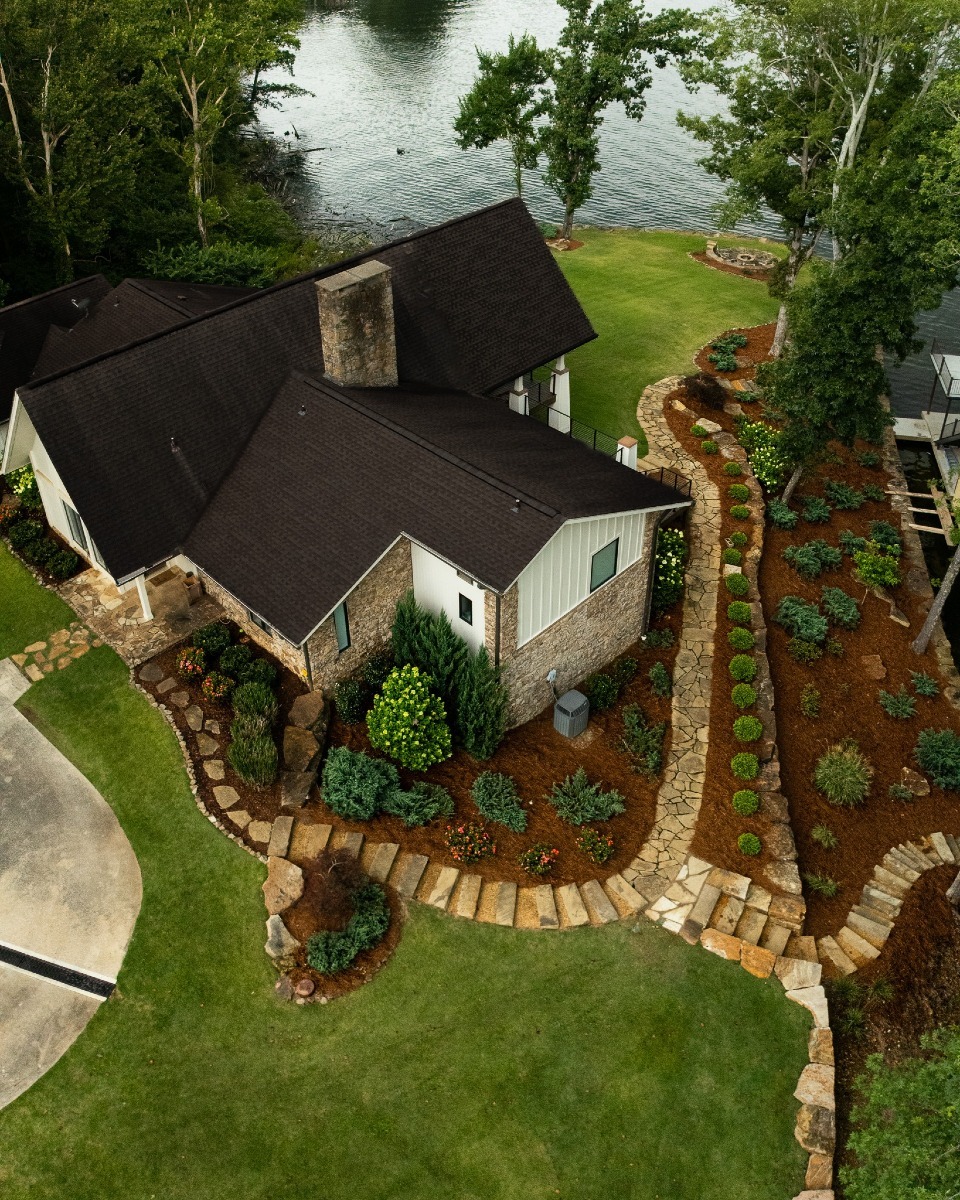 Aerial view of lakeside house with garden