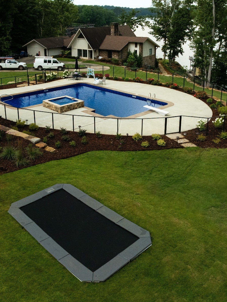 Backyard pool and in-ground trampoline