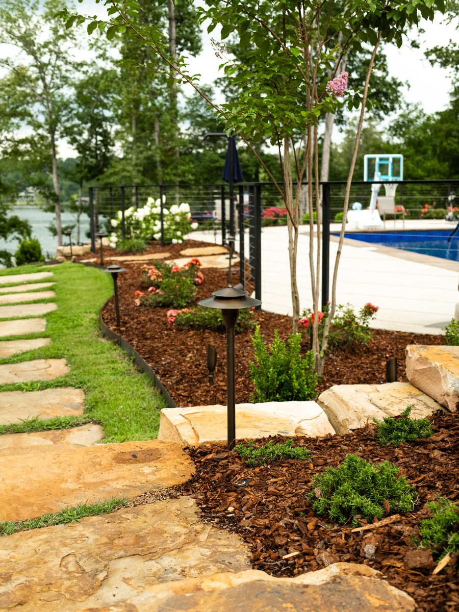 Backyard garden with stone path and pool