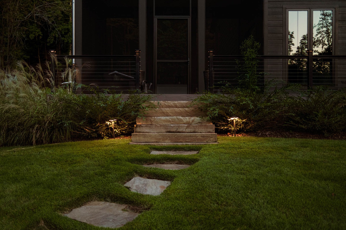 Illuminated pathway to modern porch