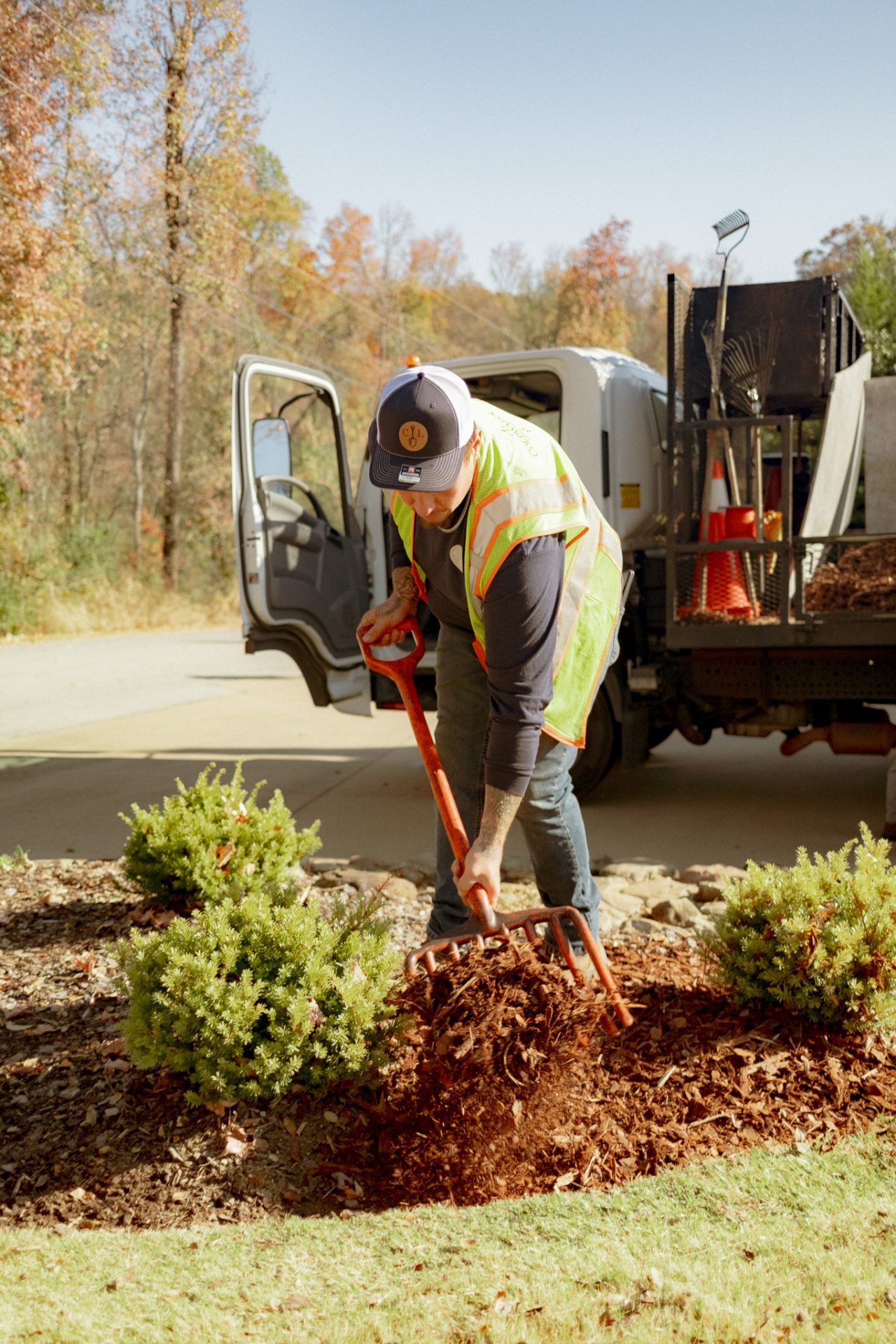 Man landscaping with mulch and shovel