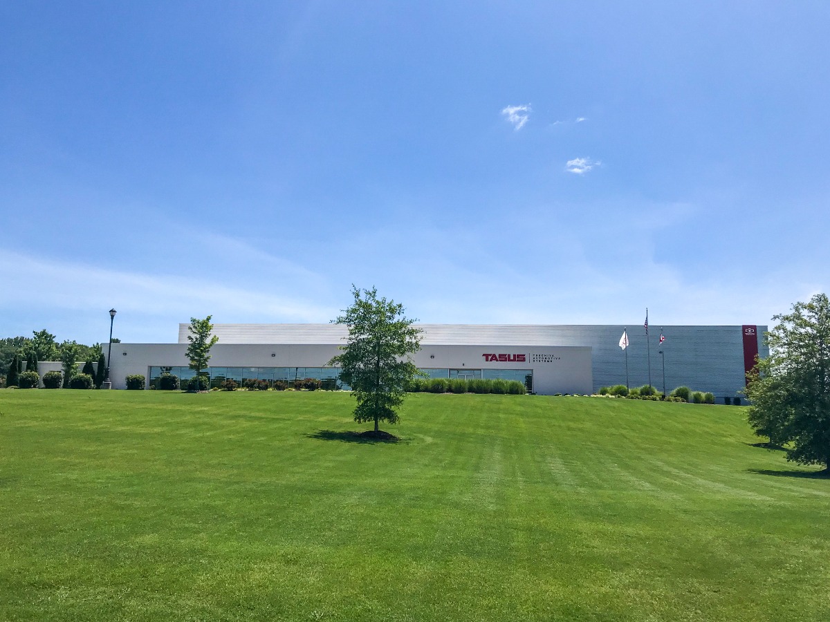 Modern industrial building with green lawn