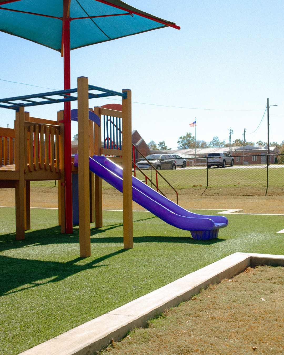 Playground slide with shade canopy.